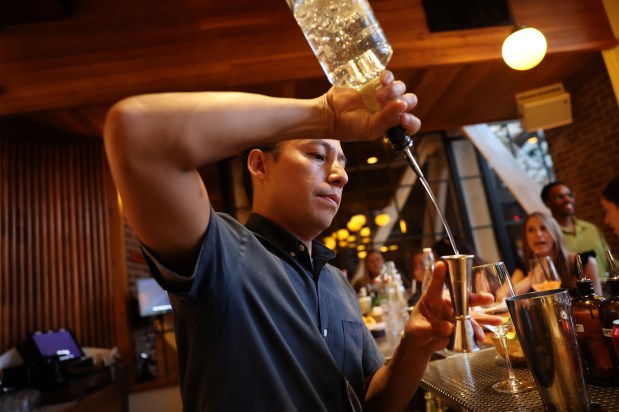Bartender Nikko Neri makes a spritz at Cindy's Rooftop on Michigan Avenue in Chicago, July 17, 2026. (Chris Sweda/Chicago Tribune)