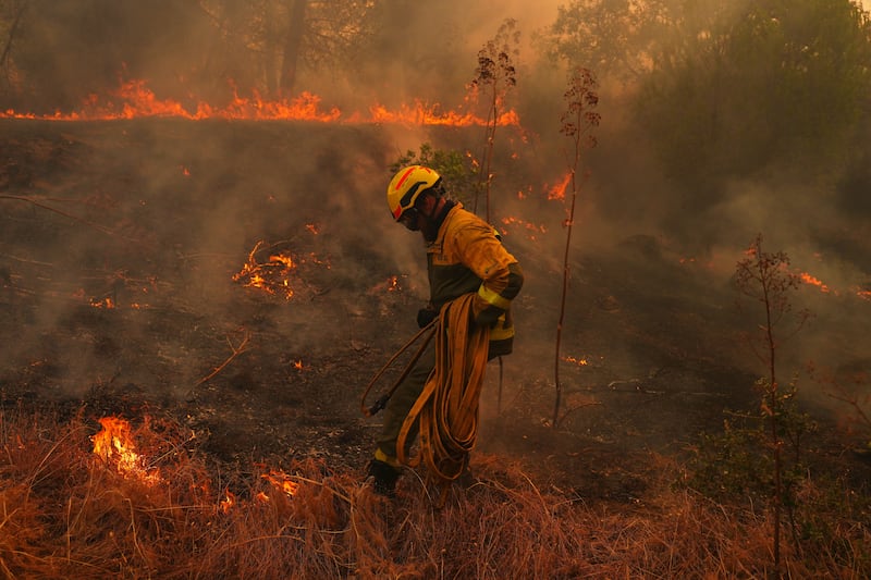 A firefighter battles a wildfire in San Martin de Valdeiglesias, west of Madrid, Spain, on Sunday (Manu Fernandez/AP)