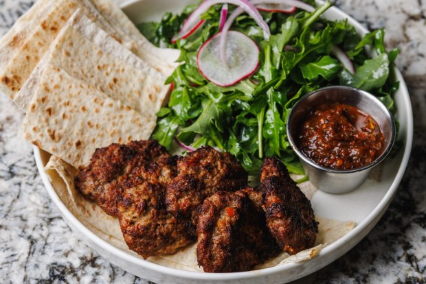Grilled Köfte with arugula, red onion and radish salad, as served at Bosforo in Normal Heights. (Kristian Carreon / The San Diego Union-Tribune)