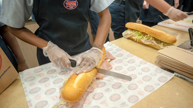 Employee making a Jersey Mike's sandwich
