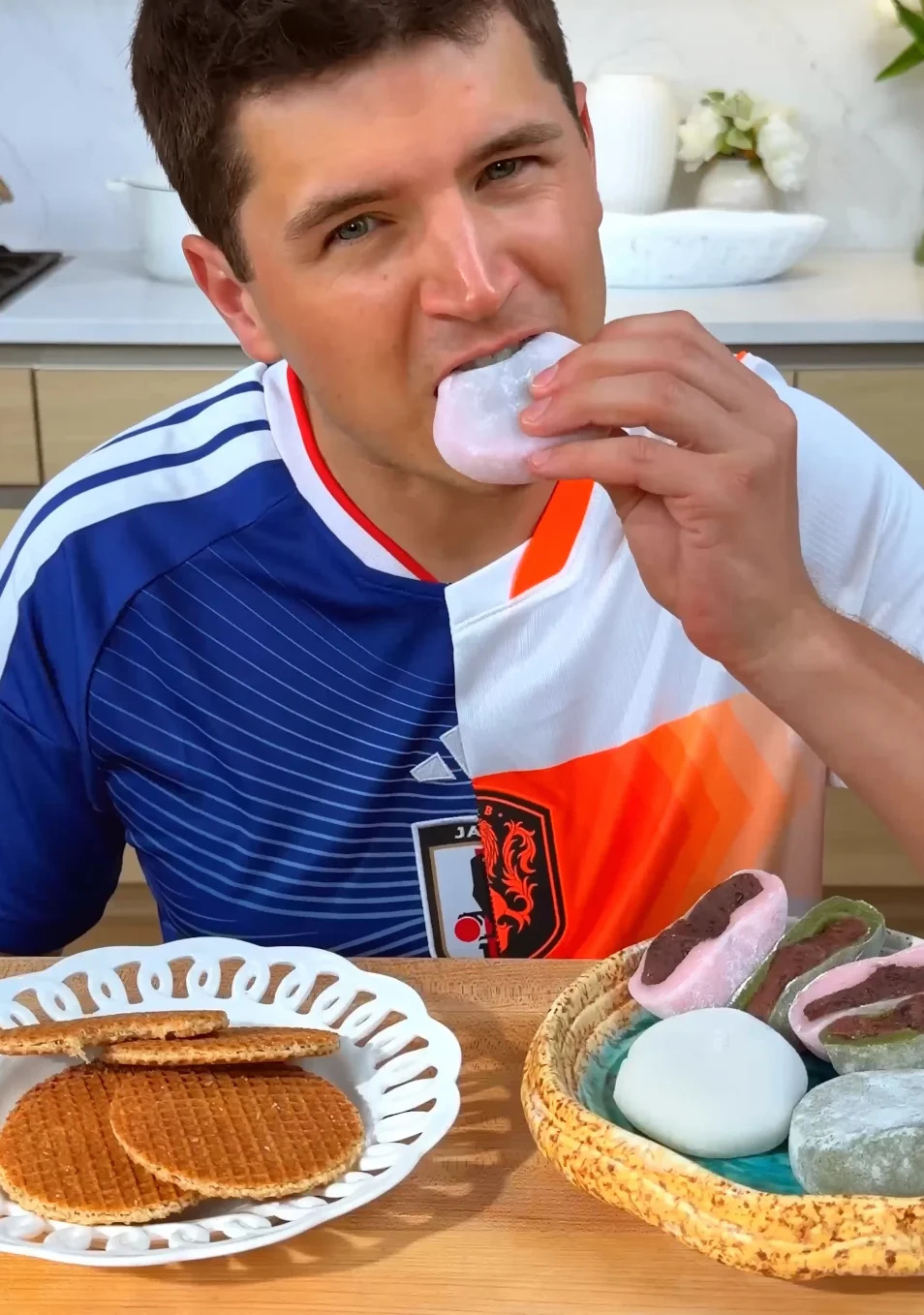 Nick DiGiovanni taking a bite out of a piece of mochi.