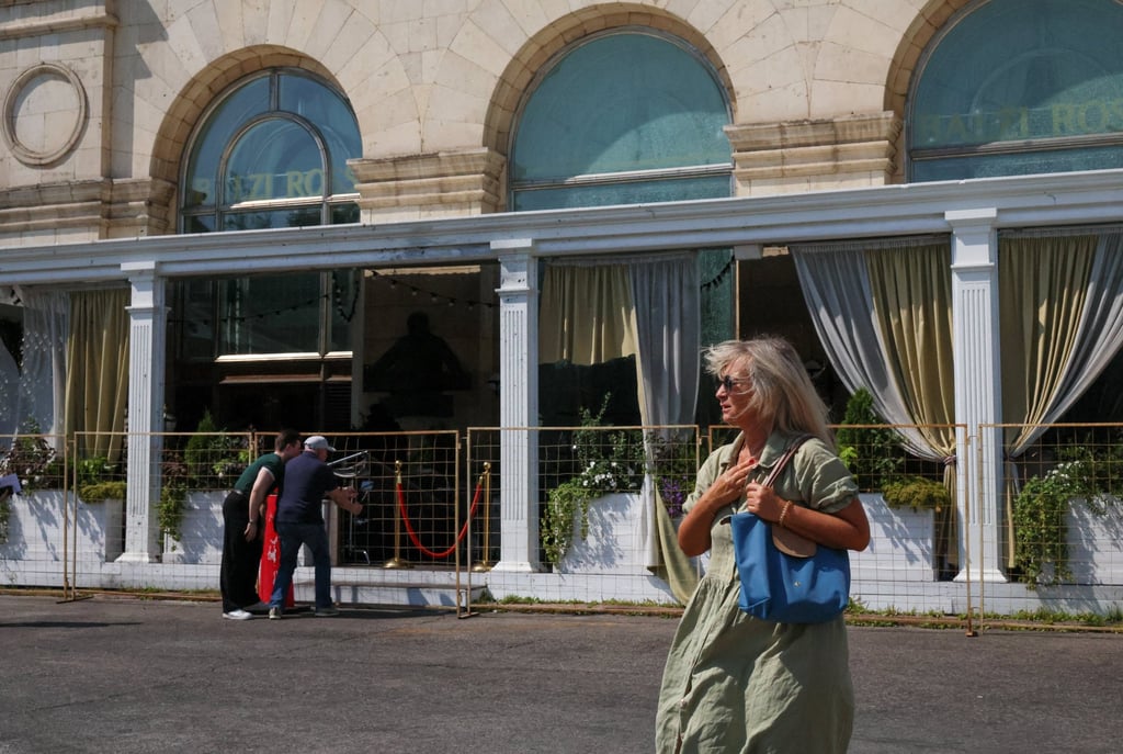 A woman walks past the fenced-off Balzi Rossi Italian restaurant on Sunday following a deadly bomb explosion in central Moscow. Photo: Reuters