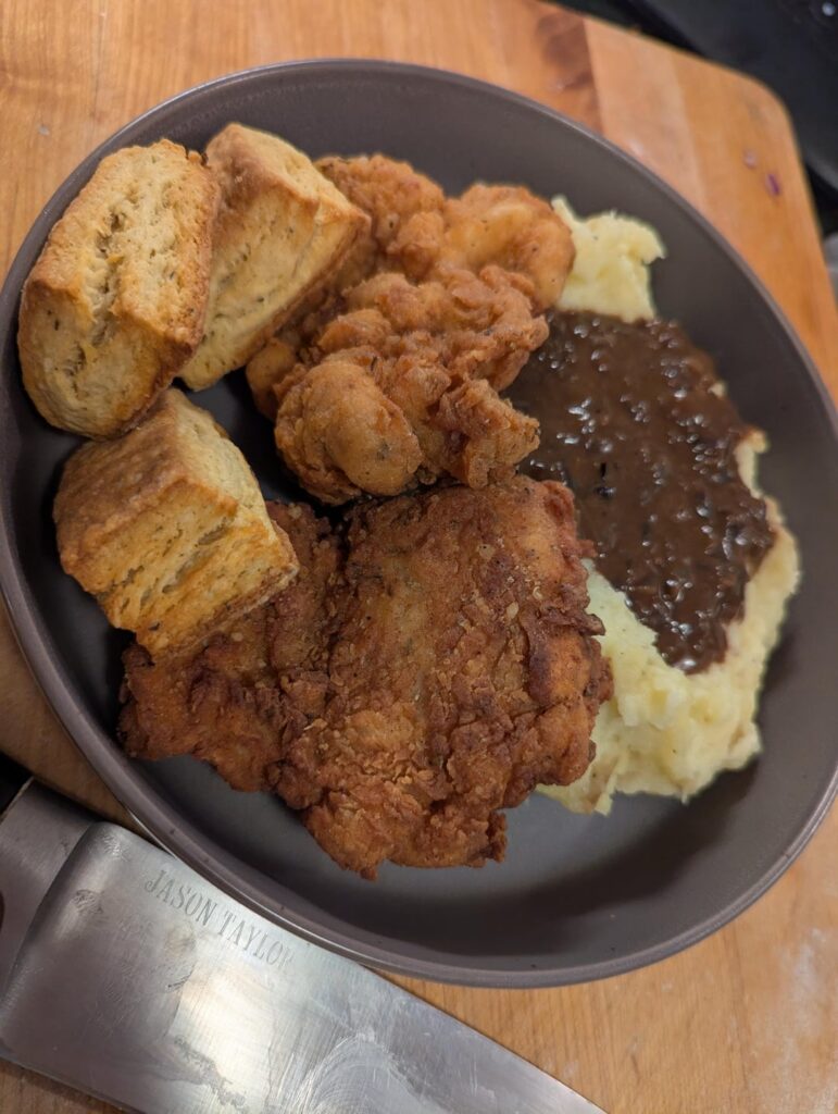 Fried chicken thighs, mashed potatoes, gravy, and toaster oven biscuits